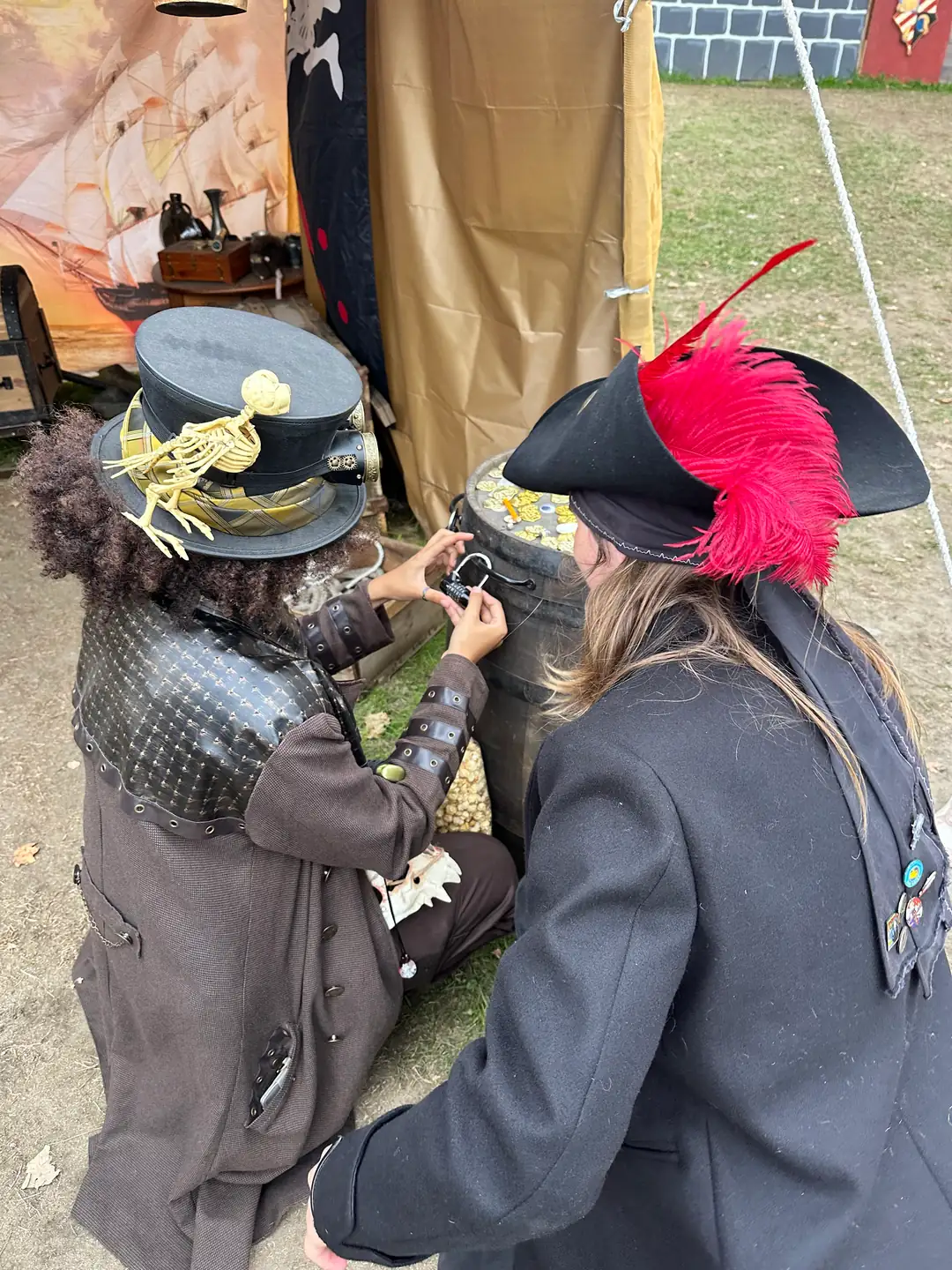 Steampunk and pirate adventurers working to open a combination lock on a treasure barrel